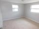 Bedroom with neutral carpeting and two windows for natural light at 4417 Kohler St, New Port Richey, FL 34652
