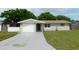 Charming single-story home with a freshly painted driveway and well-maintained lawn at 4417 Kohler St, New Port Richey, FL 34652