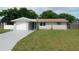 Charming single-story home with a well-maintained lawn and a freshly painted driveway at 4417 Kohler St, New Port Richey, FL 34652
