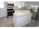 Modern kitchen with stainless steel appliances, granite countertops and white cabinetry at 4417 Kohler St, New Port Richey, FL 34652