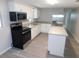 Modern kitchen features stainless steel appliances, white cabinets, and a central island at 4417 Kohler St, New Port Richey, FL 34652