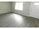 Bright living room with wood-look flooring and a white front door with a window at 4417 Kohler St, New Port Richey, FL 34652