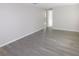 Open floor plan living room with wood-look flooring and neutral wall paint at 4417 Kohler St, New Port Richey, FL 34652