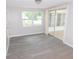 Bright living room featuring wood-look flooring and sliding glass doors at 4417 Kohler St, New Port Richey, FL 34652