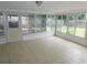 Enclosed sunroom features tiled floors and plenty of windows for natural light at 4417 Kohler St, New Port Richey, FL 34652