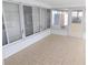 Enclosed sunroom features tiled floors and plenty of windows for natural light at 4417 Kohler St, New Port Richey, FL 34652