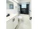 Updated bathroom featuring modern tile, white vanity, and shower and tub combo at 4638 Durney St, New Port Richey, FL 34652