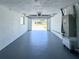 Open garage with painted floors, and visible street view, offers plenty of storage space at 4638 Durney St, New Port Richey, FL 34652
