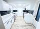 Galley kitchen featuring white cabinets, updated countertops, and stainless steel appliances at 4638 Durney St, New Port Richey, FL 34652
