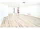 Spacious living room featuring new flooring, baseboards and light bright paint at 4638 Durney St, New Port Richey, FL 34652