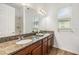 Granite countertop bathroom vanity with dual sinks illuminated by natural light from a window at 4716 Butler National Dr, Wesley Chapel, FL 33543
