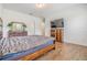 Bedroom featuring wood-look floors, coordinating dressers, and a wall-mounted flat screen TV at 4716 Butler National Dr, Wesley Chapel, FL 33543