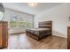 Bedroom with wood-look floors and natural light coming through the windows at 4716 Butler National Dr, Wesley Chapel, FL 33543
