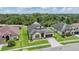 Well-manicured lawn and landscaping surround this home in a serene neighborhood setting at 4716 Butler National Dr, Wesley Chapel, FL 33543