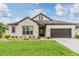 Charming one-story home with a well-manicured lawn and a two car garage at 4716 Butler National Dr, Wesley Chapel, FL 33543
