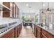 Stylish kitchen featuring stainless steel appliances, granite countertops, and access to the dining area and backyard at 4716 Butler National Dr, Wesley Chapel, FL 33543