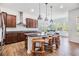 Gourmet kitchen featuring granite countertops, stainless steel appliances, and a center island with bar seating at 4716 Butler National Dr, Wesley Chapel, FL 33543