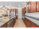 Bright kitchen with stainless appliances, granite countertops, and convenient access to dining and living spaces at 4716 Butler National Dr, Wesley Chapel, FL 33543