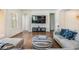 Bright living room features a large flat screen TV, comfortable seating, and modern decor at 4716 Butler National Dr, Wesley Chapel, FL 33543