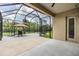 Covered patio offers outdoor living space with a dining set and views of the lush backyard at 4716 Butler National Dr, Wesley Chapel, FL 33543