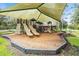 Shaded playground with slides, climbing structures, and a soft landing surface at 4716 Butler National Dr, Wesley Chapel, FL 33543