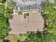 Aerial view of condo showing roof detail, parking, and surrounding lush trees at 4735 Winslow Beacon # 14, Sarasota, FL 34235