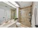 Nicely updated bathroom featuring a tiled shower with glass doors, modern fixtures, and a toilet at 4735 Winslow Beacon # 14, Sarasota, FL 34235
