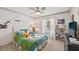 Bright bedroom featuring a ceiling fan and a large window with a lively bed spread and cheerful decorations at 4735 Winslow Beacon # 14, Sarasota, FL 34235