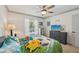 Well-lit bedroom with a ceiling fan, dresser, and a window overlooking the exterior at 4735 Winslow Beacon # 14, Sarasota, FL 34235