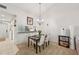 Cozy dining space featuring a modern chandelier and a view of the pass through to the kitchen at 4735 Winslow Beacon # 14, Sarasota, FL 34235