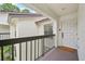 Stylish condo entry featuring a covered landing, a white door, and a 'so happy you're here' welcome mat at 4735 Winslow Beacon # 14, Sarasota, FL 34235