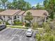 Beautiful condominium with lush landscaping, parking, and outdoor stairs leading to the second level at 4735 Winslow Beacon # 14, Sarasota, FL 34235