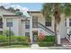 Inviting condo exterior featuring well-maintained landscaping and a classic stucco facade at 4735 Winslow Beacon # 14, Sarasota, FL 34235