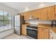 Well-lit kitchen features stainless steel appliances and granite countertops at 4735 Winslow Beacon # 14, Sarasota, FL 34235