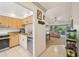 Well-equipped kitchen with stainless steel appliances and granite countertops, leading to the living room at 4735 Winslow Beacon # 14, Sarasota, FL 34235