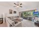Bright living room with large sectional, ceiling fan, and screened lanai access for outdoor living at 4735 Winslow Beacon # 14, Sarasota, FL 34235