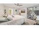 Spacious bedroom with a balcony, television, and comfortable furniture at 4735 Winslow Beacon # 14, Sarasota, FL 34235
