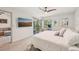 Spacious bedroom with a balcony, television, and comfortable furniture at 4735 Winslow Beacon # 14, Sarasota, FL 34235
