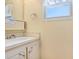 Clean bathroom with a bright window, single sink, and plenty of natural light at 4904 Winged Foot Ave, Sarasota, FL 34234