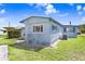 Charming home with well-maintained lawn and inviting exterior, freshly painted in light blue at 4904 Winged Foot Ave, Sarasota, FL 34234