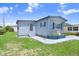 Single-story home boasting a cozy porch area and lush green lawn at 4904 Winged Foot Ave, Sarasota, FL 34234