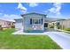 Charming single-story home with a covered carport and well-manicured lawn at 4904 Winged Foot Ave, Sarasota, FL 34234