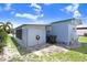 Rear view of home featuring a paved patio area and green outdoor space at 4904 Winged Foot Ave, Sarasota, FL 34234