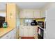 Efficient kitchen equipped with essential appliances and ample cabinet storage at 4904 Winged Foot Ave, Sarasota, FL 34234