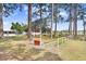 Shuffleboard courts surrounded by tall trees on a sunny day at 4904 Winged Foot Ave, Sarasota, FL 34234