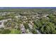 Beautiful aerial view of the neighborhood with lush greenery and a serene pond in the background at 4959 Felecity Way, Palm Harbor, FL 34685
