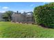 Lush backyard featuring a large screened-in lanai and meticulously maintained lawn at 4959 Felecity Way, Palm Harbor, FL 34685