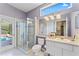 Bright bathroom features tiled floors, glass shower, single sink vanity and a large window for natural light at 4959 Felecity Way, Palm Harbor, FL 34685