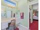 Bright primary bathroom with vanity, dual mirrors and neutral tile at 4959 Felecity Way, Palm Harbor, FL 34685