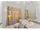 Functional bathroom with a shower, vanity, and a mirrored cabinet at 4959 Felecity Way, Palm Harbor, FL 34685